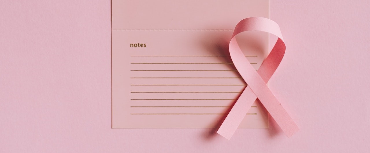 Close-Up Shot of a Pink Ribbon on a Calendar | Breast Cancer Car Donations